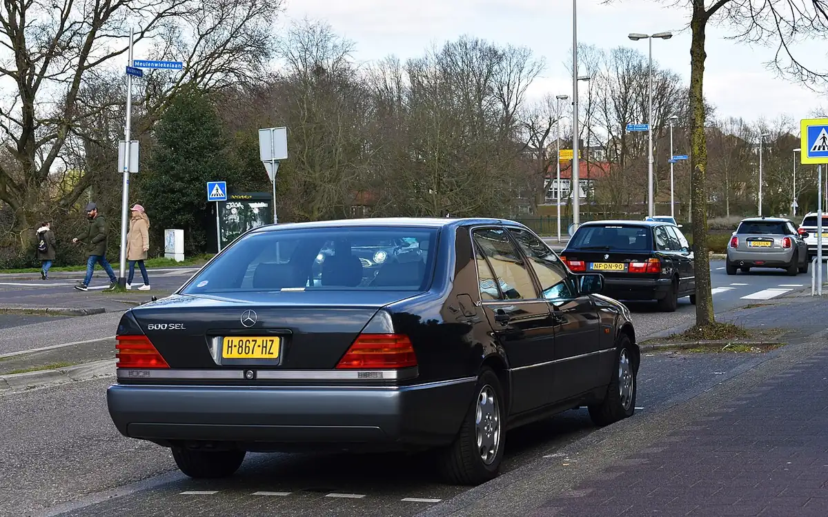 BMW and Mercedes luxury sedans facing each other