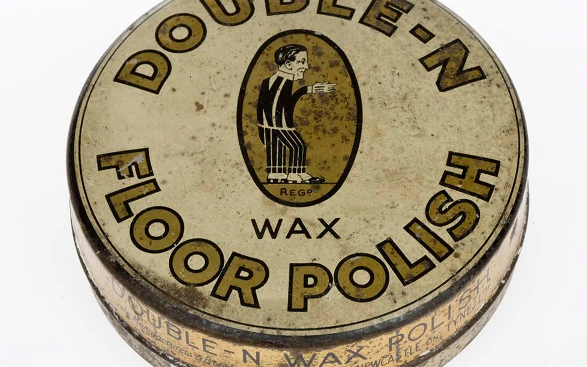 Car polish bottle and car wax container side by side on a fender
