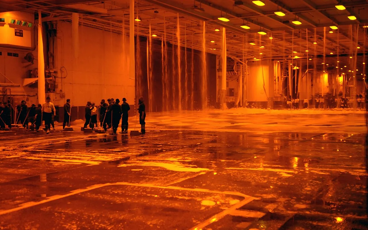 Car covered in thick cleaning foam during a professional foam wash