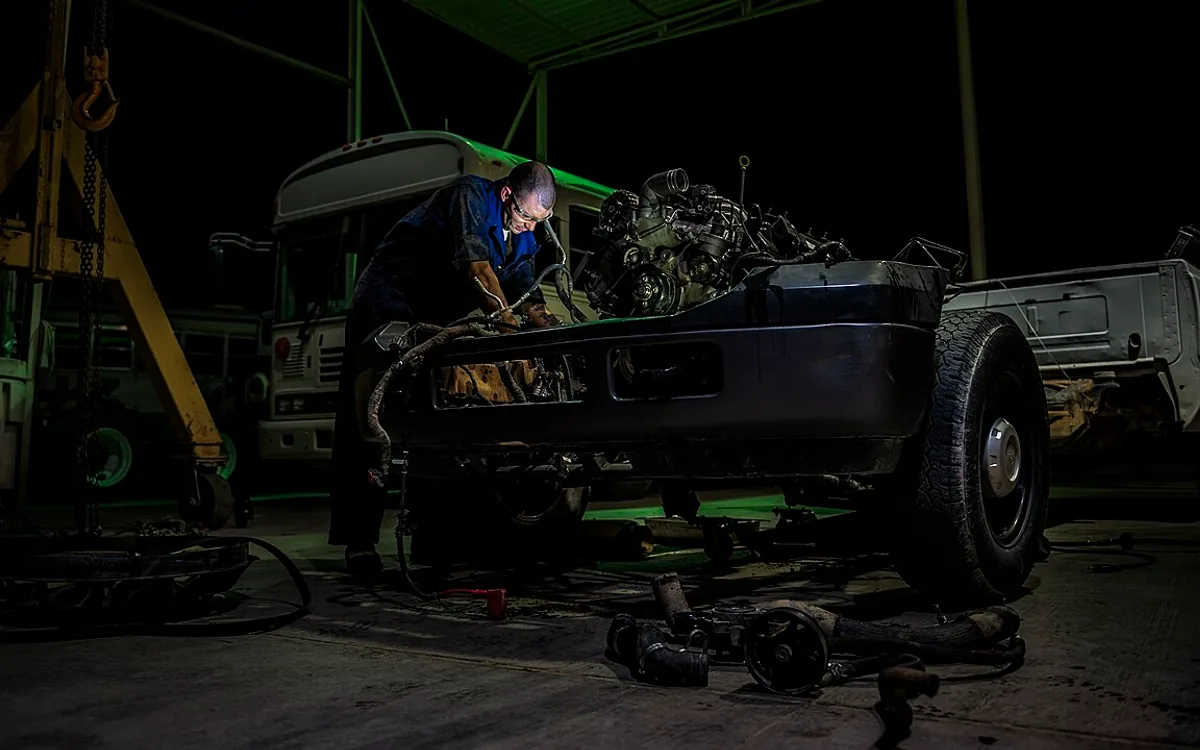 Disassembled car engine on a workshop bench ready for overhaul