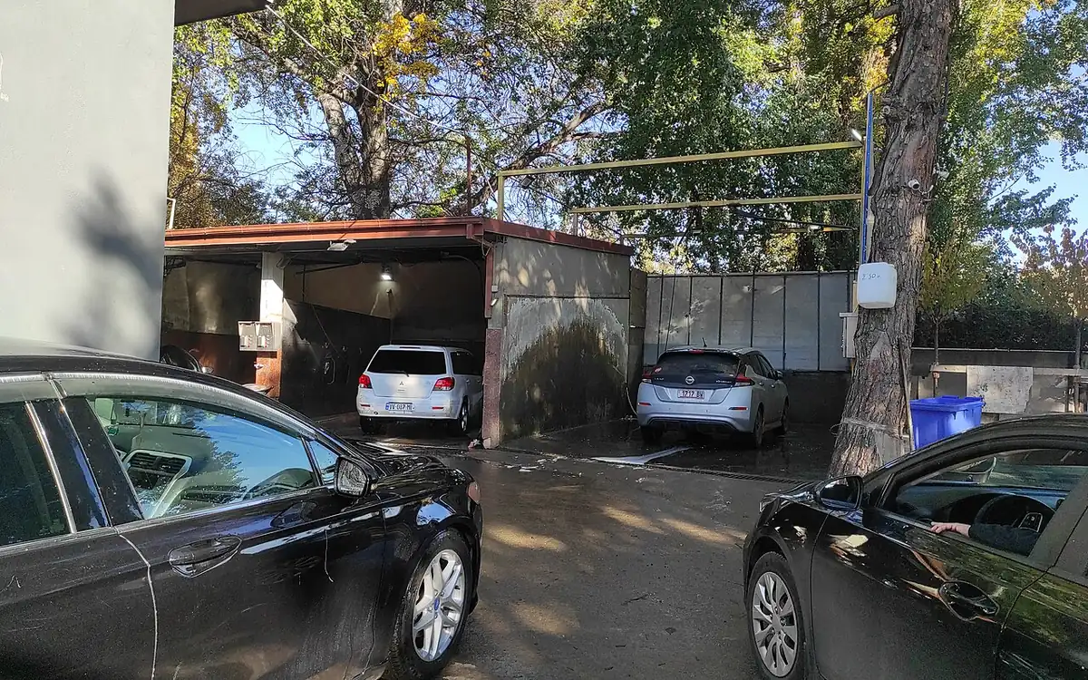 Professional car wash bay in Delhi NCR with a car being foam washed