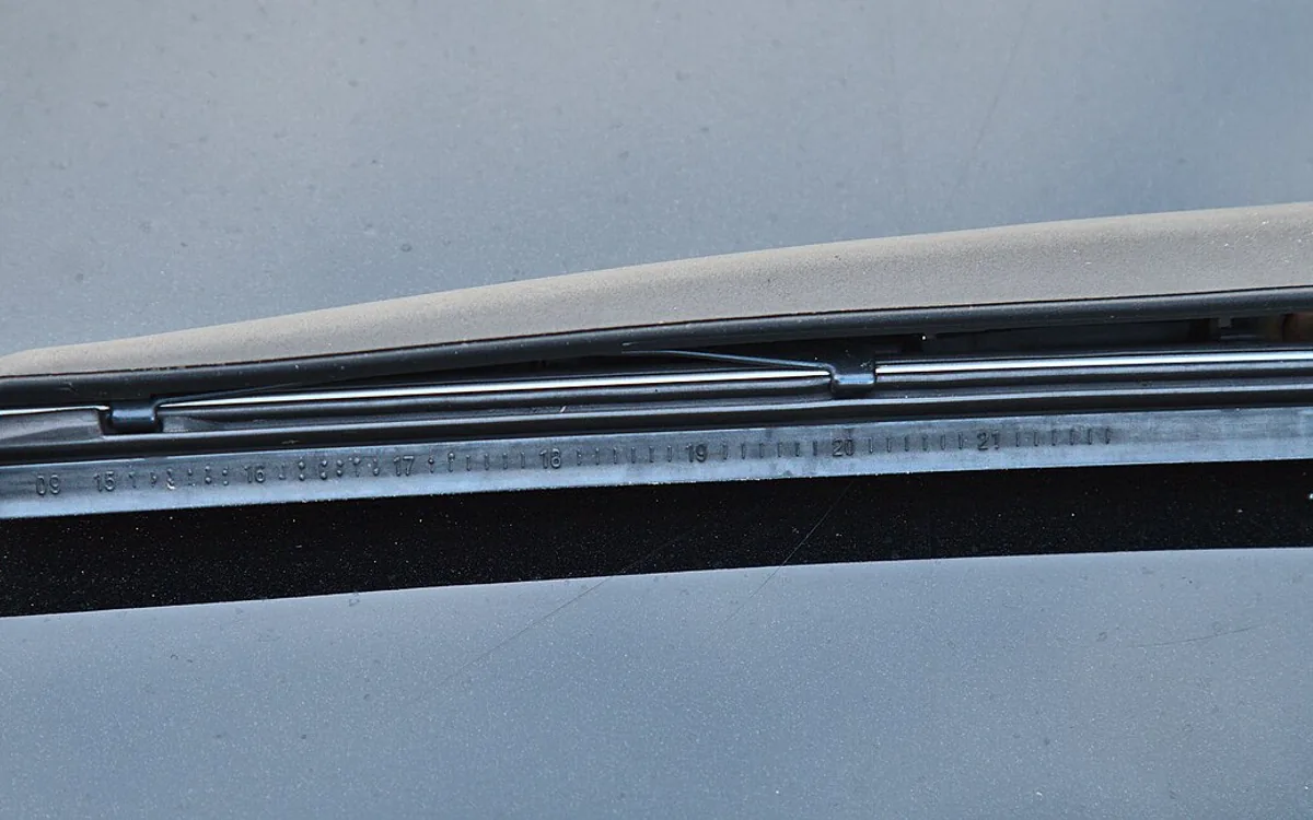 New wiper blade being fitted on a car windshield