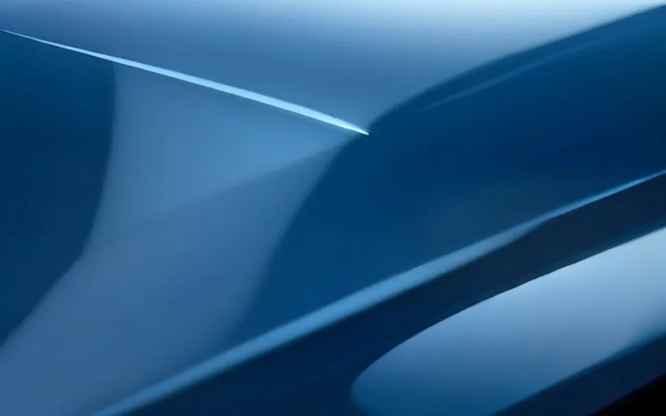 Crystal clear paint protection film on a glossy dark blue car paint surface